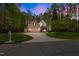 Charming two-story brick home with a well-manicured lawn and a circular driveway at 524 Birdsong Ln, Hurdle Mills, NC 27541