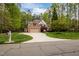 Charming two-story brick home with a well-manicured lawn and a circular driveway at 524 Birdsong Ln, Hurdle Mills, NC 27541