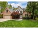 Charming two-story brick home with manicured lawn and mature trees at 524 Birdsong Ln, Hurdle Mills, NC 27541