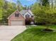 Two-story brick home with attached garage and landscaped front yard at 524 Birdsong Ln, Hurdle Mills, NC 27541