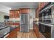 Modern kitchen features stainless steel appliances, custom cabinetry, and granite countertops at 524 Birdsong Ln, Hurdle Mills, NC 27541