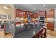 Well-equipped kitchen featuring stainless steel appliances, a large island, and granite countertops at 524 Birdsong Ln, Hurdle Mills, NC 27541