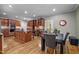 Open kitchen with island, stainless steel appliances, and adjacent dining area at 524 Birdsong Ln, Hurdle Mills, NC 27541