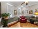 Comfortable living room with natural light, and a red accent chair at 524 Birdsong Ln, Hurdle Mills, NC 27541
