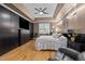Spacious primary bedroom with tray ceiling, hardwood floors, and custom storage solutions at 524 Birdsong Ln, Hurdle Mills, NC 27541