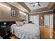 Relaxing primary bedroom featuring a tray ceiling, hardwood floors, and stylish decor at 524 Birdsong Ln, Hurdle Mills, NC 27541
