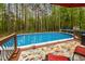 Outdoor pool with surrounding deck, surrounded by a wooded area at 524 Birdsong Ln, Hurdle Mills, NC 27541