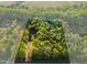 Aerial view displaying a home with lush tree coverage around property's outline at 580 Greenbriar Farm Trl, Siler City, NC 27344
