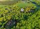 An aerial view shows a home tucked away in an area of trees and foliage at 580 Greenbriar Farm Trl, Siler City, NC 27344