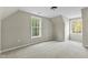 Carpeted bedroom boasting natural light through dual windows at 580 Greenbriar Farm Trl, Siler City, NC 27344