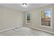 Bright bedroom featuring laminate floors and two windows offering natural light and outdoor views at 580 Greenbriar Farm Trl, Siler City, NC 27344
