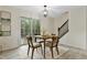 Cozy dining area featuring a wooden table, comfortable chairs, and a sliding door leading to the outside at 580 Greenbriar Farm Trl, Siler City, NC 27344