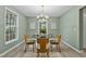 Charming dining room with a glass-top table, stylish chairs, and decorative lighting fixture at 580 Greenbriar Farm Trl, Siler City, NC 27344