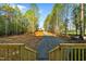 View from the porch of the gravel driveway lined with a canopy of lush trees at 580 Greenbriar Farm Trl, Siler City, NC 27344