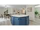 Chic kitchen island with a white countertop, blue cabinetry, and seating for casual dining at 580 Greenbriar Farm Trl, Siler City, NC 27344