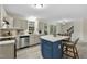 Well-lit kitchen featuring a center island, stainless steel appliances, and ample countertop space at 580 Greenbriar Farm Trl, Siler City, NC 27344