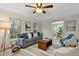 Inviting living room with neutral walls, plush seating, and open access to the dining room at 580 Greenbriar Farm Trl, Siler City, NC 27344