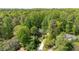Aerial view of a brick home nestled among dense green trees at 5912 Weather Rock Ct, Raleigh, NC 27613