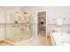 Elegant bathroom featuring a glass enclosed shower, soaking tub, and walk-in closet at 5912 Weather Rock Ct, Raleigh, NC 27613