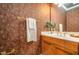 Charming powder room with Roman themed wallpaper, and gold fixtures at 5912 Weather Rock Ct, Raleigh, NC 27613