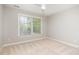 Bright, airy bedroom with a ceiling fan and ample natural light streaming through a large window at 5912 Weather Rock Ct, Raleigh, NC 27613