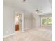 Bright bedroom with neutral paint and a ceiling fan, leading to a private bathroom, is ready to move in at 5912 Weather Rock Ct, Raleigh, NC 27613