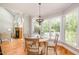 Bright breakfast nook features hardwood floors, backyard views, and a modern light fixture at 5912 Weather Rock Ct, Raleigh, NC 27613