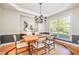 Inviting dining room with a farmhouse table, stylish chandelier, and natural light, perfect for gatherings at 5912 Weather Rock Ct, Raleigh, NC 27613