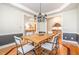 Elegant dining room showcasing a modern light fixture, wainscoting, and open access to the kitchen at 5912 Weather Rock Ct, Raleigh, NC 27613