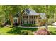 Brick home nestled amongst mature trees and lush landscaping at 5912 Weather Rock Ct, Raleigh, NC 27613