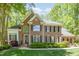 Charming brick home with black shutters, lush landscaping and a manicured lawn on a sunny day at 5912 Weather Rock Ct, Raleigh, NC 27613