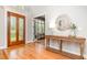 Inviting foyer featuring a wooden door with glass accents and gleaming hardwood floors at 5912 Weather Rock Ct, Raleigh, NC 27613