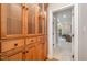 Elegant hallway features a custom wood cabinet with glass doors, adding charm and functionality at 5912 Weather Rock Ct, Raleigh, NC 27613