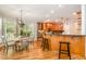 Bright kitchen featuring wood cabinets, stainless appliances, and a breakfast bar, seamlessly connected to the dining area at 5912 Weather Rock Ct, Raleigh, NC 27613