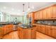 Gourmet kitchen featuring custom cabinets, stainless steel appliances, granite countertops, and an island gas cooktop at 5912 Weather Rock Ct, Raleigh, NC 27613