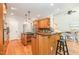 Stylish kitchen with wood cabinets, granite counters, and stainless steel appliances, open to the living area at 5912 Weather Rock Ct, Raleigh, NC 27613