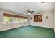 Versatile room with large windows, custom shelving, and neutral wall colors, perfect for a home theater at 5912 Weather Rock Ct, Raleigh, NC 27613
