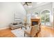 Cozy living room featuring a fireplace, hardwood floors, and large windows, perfect for relaxation and entertaining at 5912 Weather Rock Ct, Raleigh, NC 27613