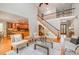 Bright living room boasts hardwood floors, staircase, and access to the kitchen, creating an inviting atmosphere at 5912 Weather Rock Ct, Raleigh, NC 27613