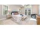 Bright primary bedroom with vaulted ceilings, sitting area, and large windows at 5912 Weather Rock Ct, Raleigh, NC 27613