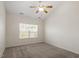 Neutral bedroom with ceiling fan and large window with backyard view at 632 Hunters Ridge Dr, Fuquay Varina, NC 27526