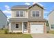 Charming two-story home featuring a one-car garage and a welcoming front porch at 632 Hunters Ridge Dr, Fuquay Varina, NC 27526