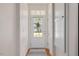 Hallway with hardwood flooring leads past a coat closet to the entry door at 632 Hunters Ridge Dr, Fuquay Varina, NC 27526