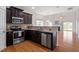 Spacious kitchen features stainless steel appliances, dark cabinets, and granite countertops at 632 Hunters Ridge Dr, Fuquay Varina, NC 27526
