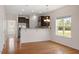 Bright kitchen featuring breakfast bar, stainless steel refrigerator, and hardwood floors at 632 Hunters Ridge Dr, Fuquay Varina, NC 27526