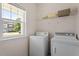 Bright laundry area with side-by-side appliances, plus a window for natural light at 632 Hunters Ridge Dr, Fuquay Varina, NC 27526