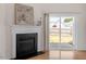 Living room fireplace detail with backyard view through sliding glass door at 632 Hunters Ridge Dr, Fuquay Varina, NC 27526