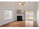 Bright living room featuring a fireplace, hardwood floors, and natural light at 632 Hunters Ridge Dr, Fuquay Varina, NC 27526