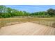 Wooden deck overlooking a large grassy backyard, perfect for outdoor enjoyment at 66 Privette Way, Zebulon, NC 27597
