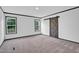 Spacious bedroom featuring natural light, modern trim, and a sliding barn door at 66 Privette Way, Zebulon, NC 27597